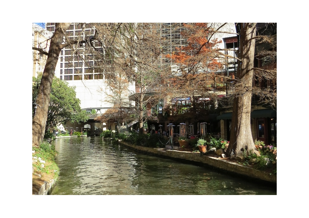 Riverwalk pathways among restaurants and buildings.